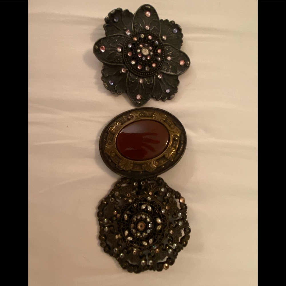 - Three Beth Frank handmade belt buckles